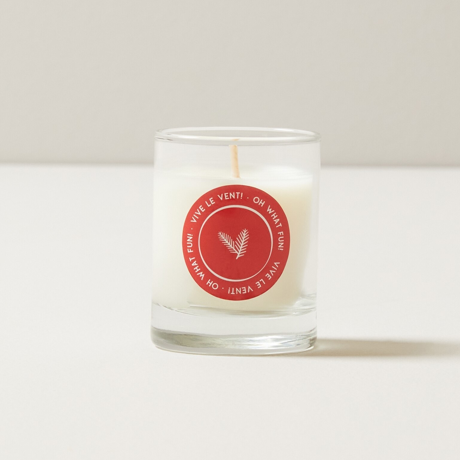 A candle in a small glass jar