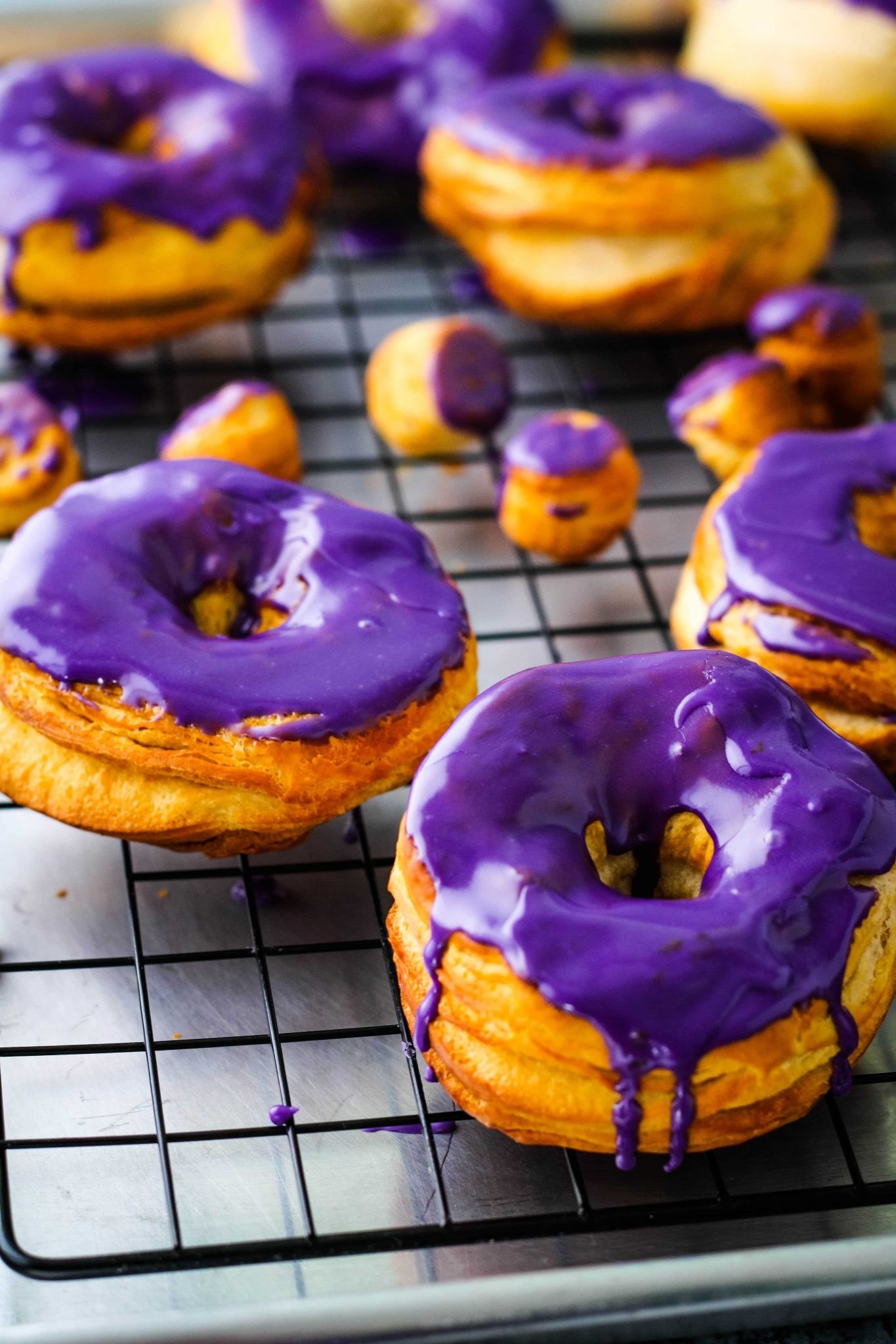 purple glazed donuts on a wire rack