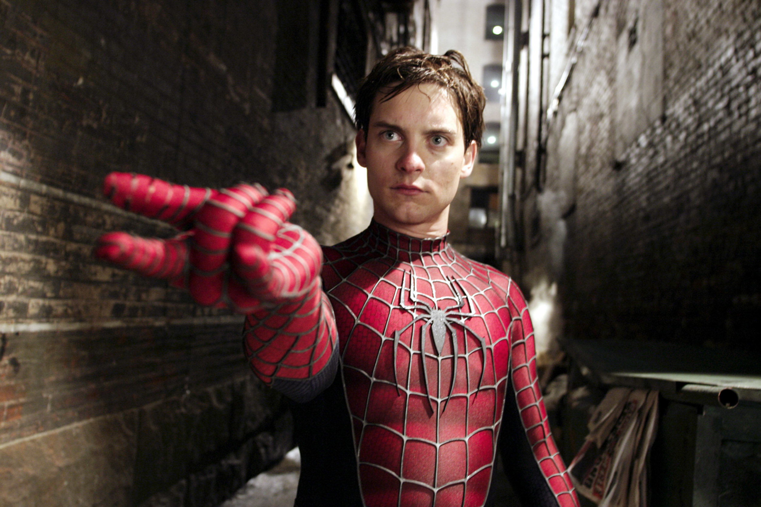Toby Maguire as Spider-Man shooting a web