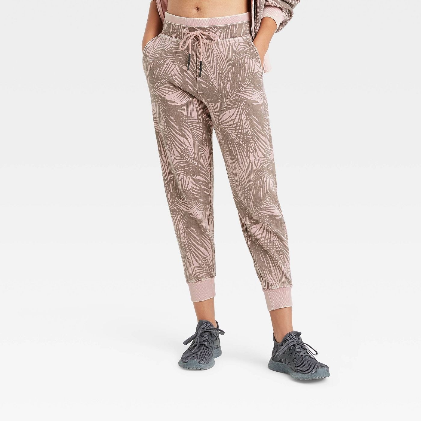 model wearing light pant joggers with leafy print