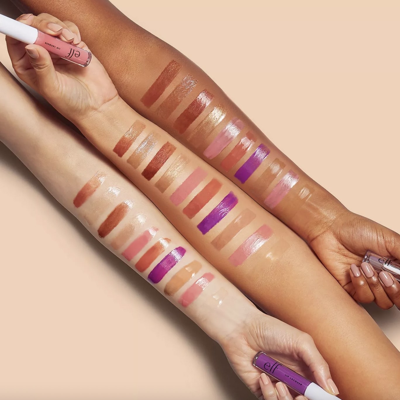 A set of lip lacquer swatches on the arms of three different skin tones