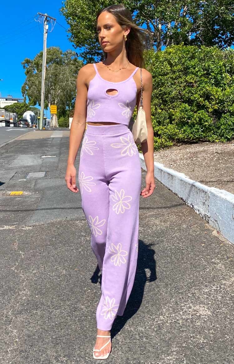 model in cropped cutout cami and wide leg pants with flowers