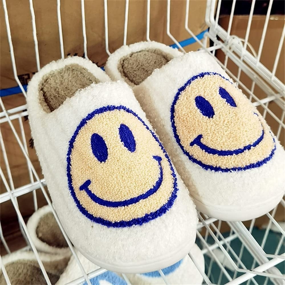 a pair of fuzzy slippers with smiley faces on the front