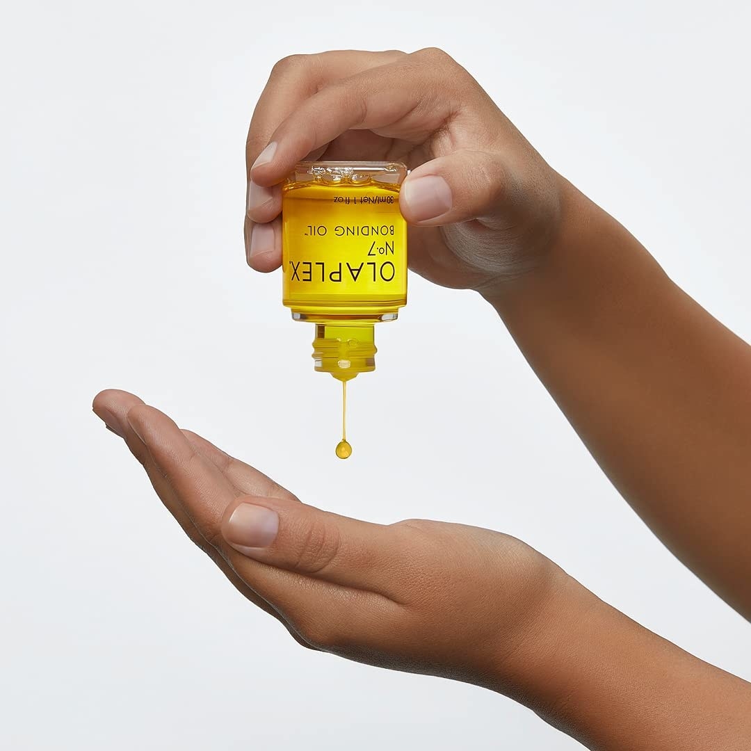 a person dropping some of the repairing oil into their palm