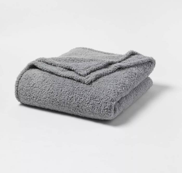 An image of a grey Sherpa bed blanket