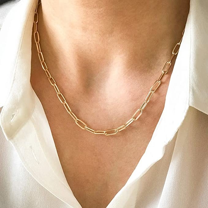 a close up of the link chain necklace around someone&#x27;s neck