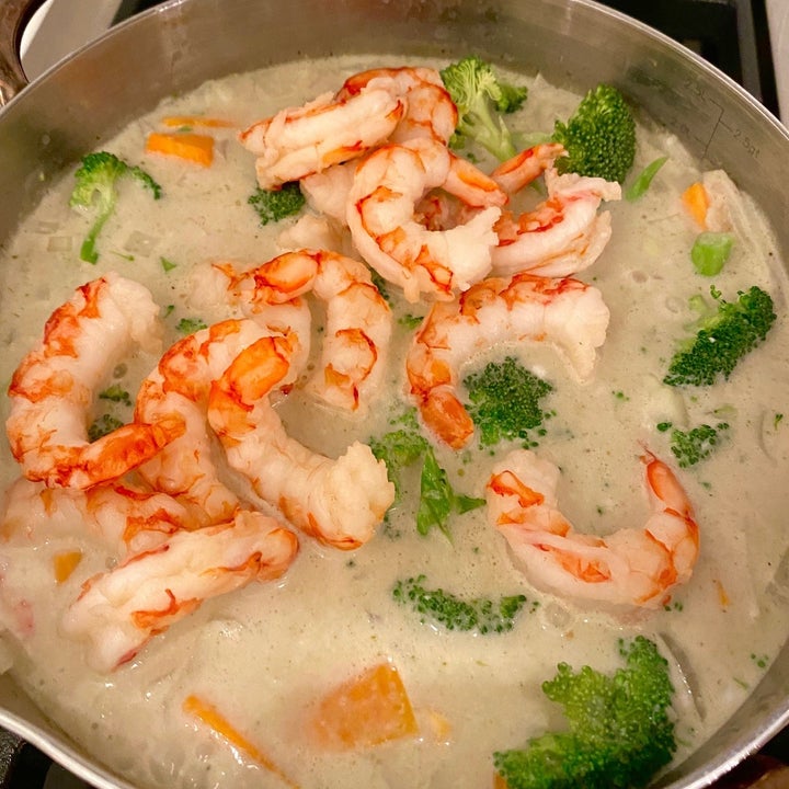 A pot of Thai green curry with shrimp.