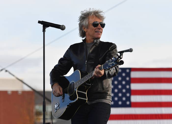 Jon Bon Jovi playing his guitar onstage