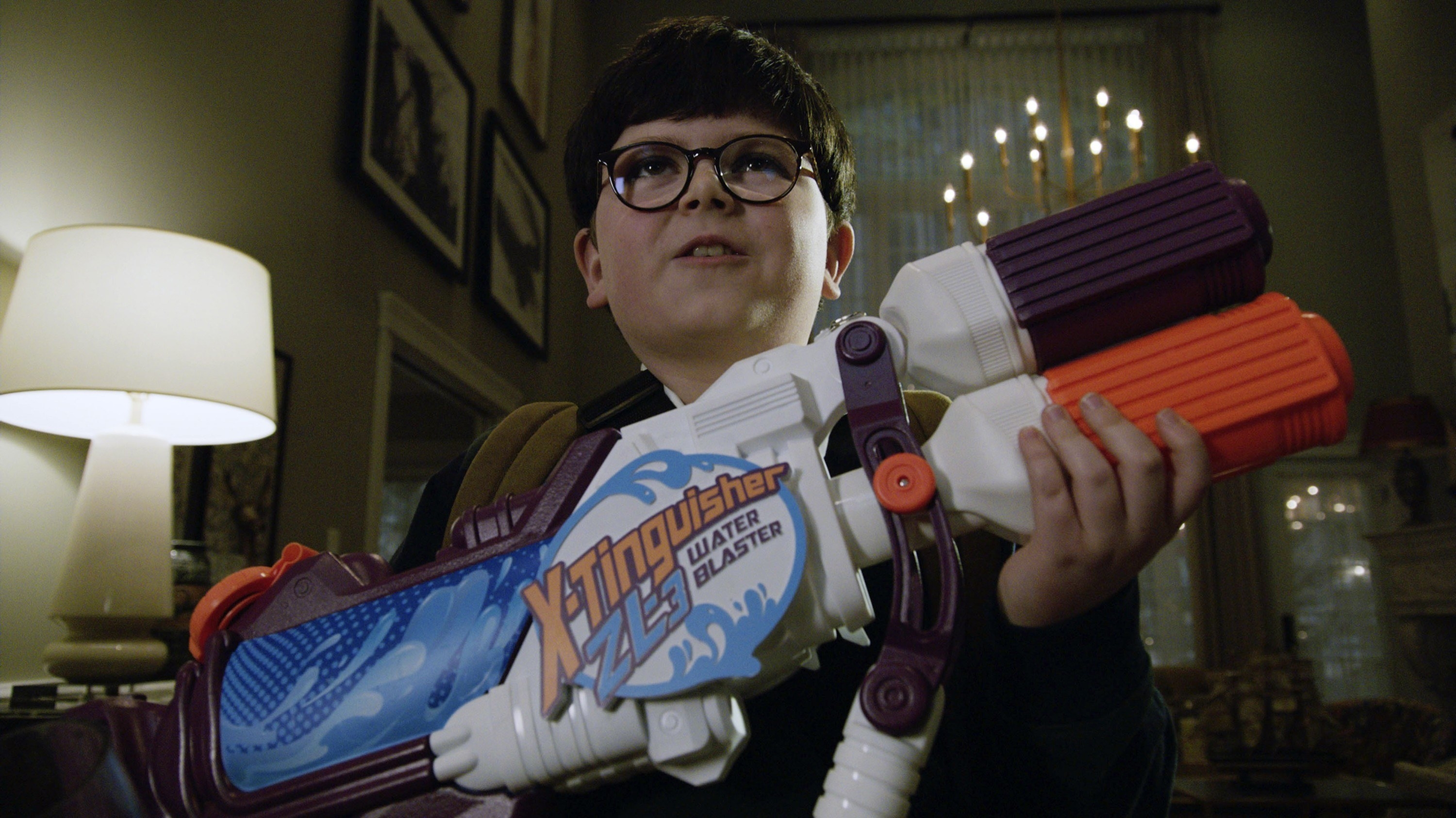 Buzz stands with a giant water gun