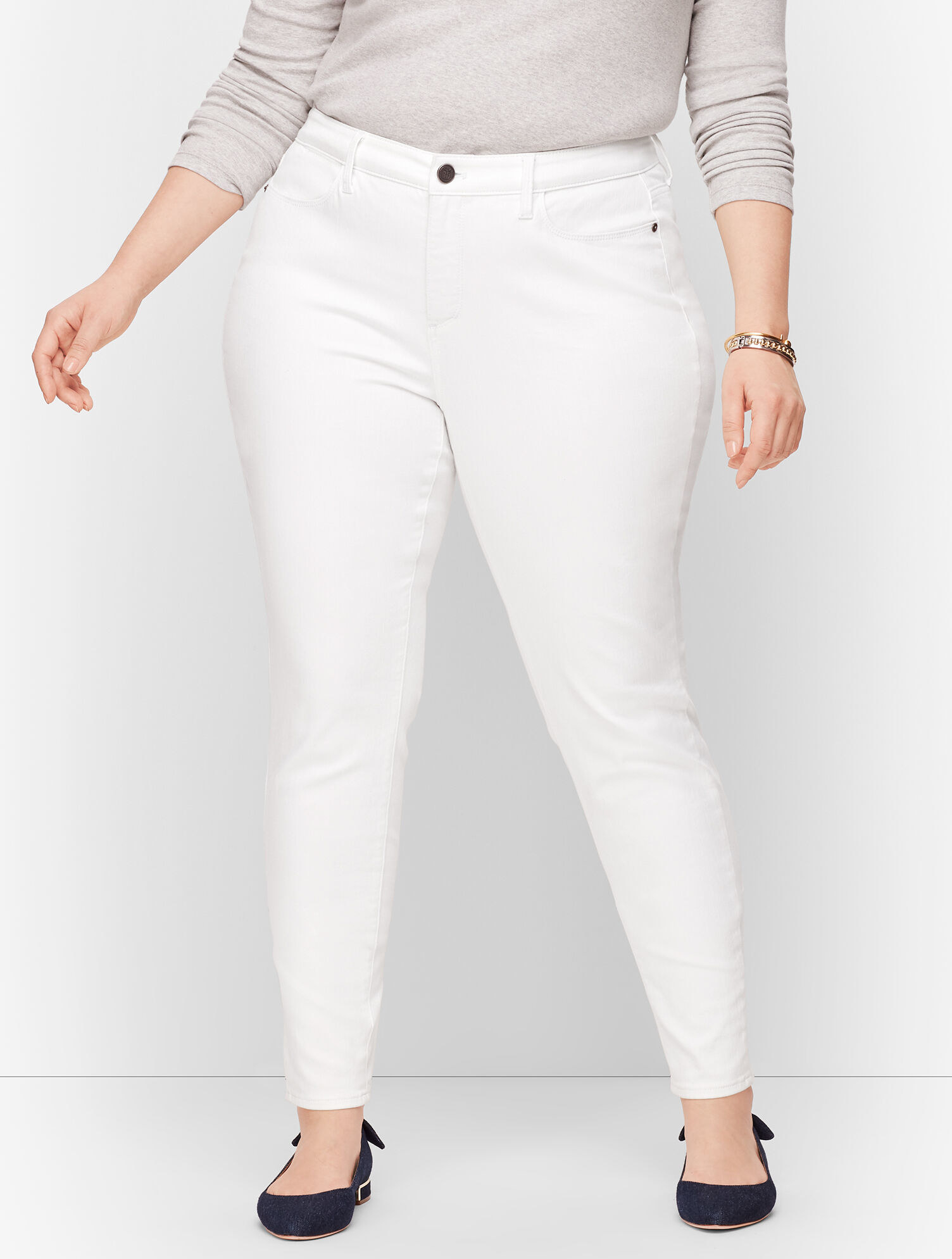Model wearing white jeggings