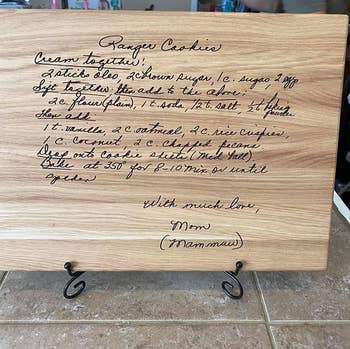 Reviewer photo of the cutting board engraved with their grandmother's handwritten cookie recipe