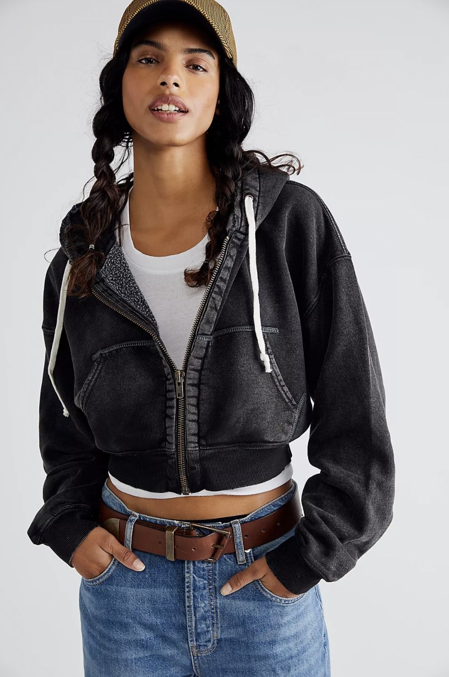 Model wearing the black hoodie with high waisted jeans