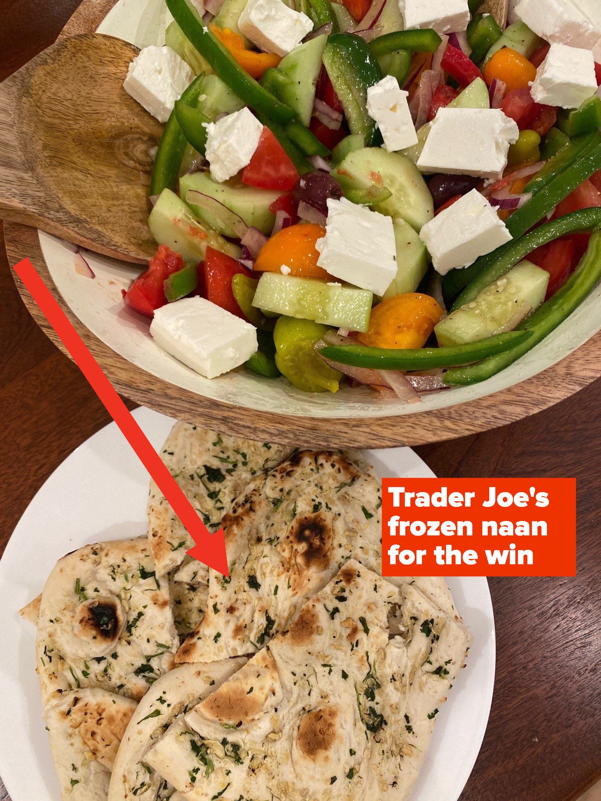 A Greek salad with garlic naan