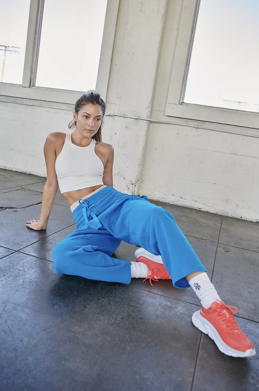 Model lounging in the blue sweats during a workout
