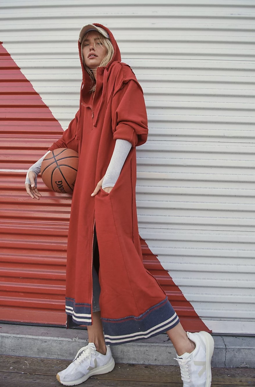 Model wearing the red maxi hooded sweatshirt with blue trim