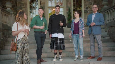 Alexis, Patrick, David, Stevie and a man standing on the steps of a bunglow