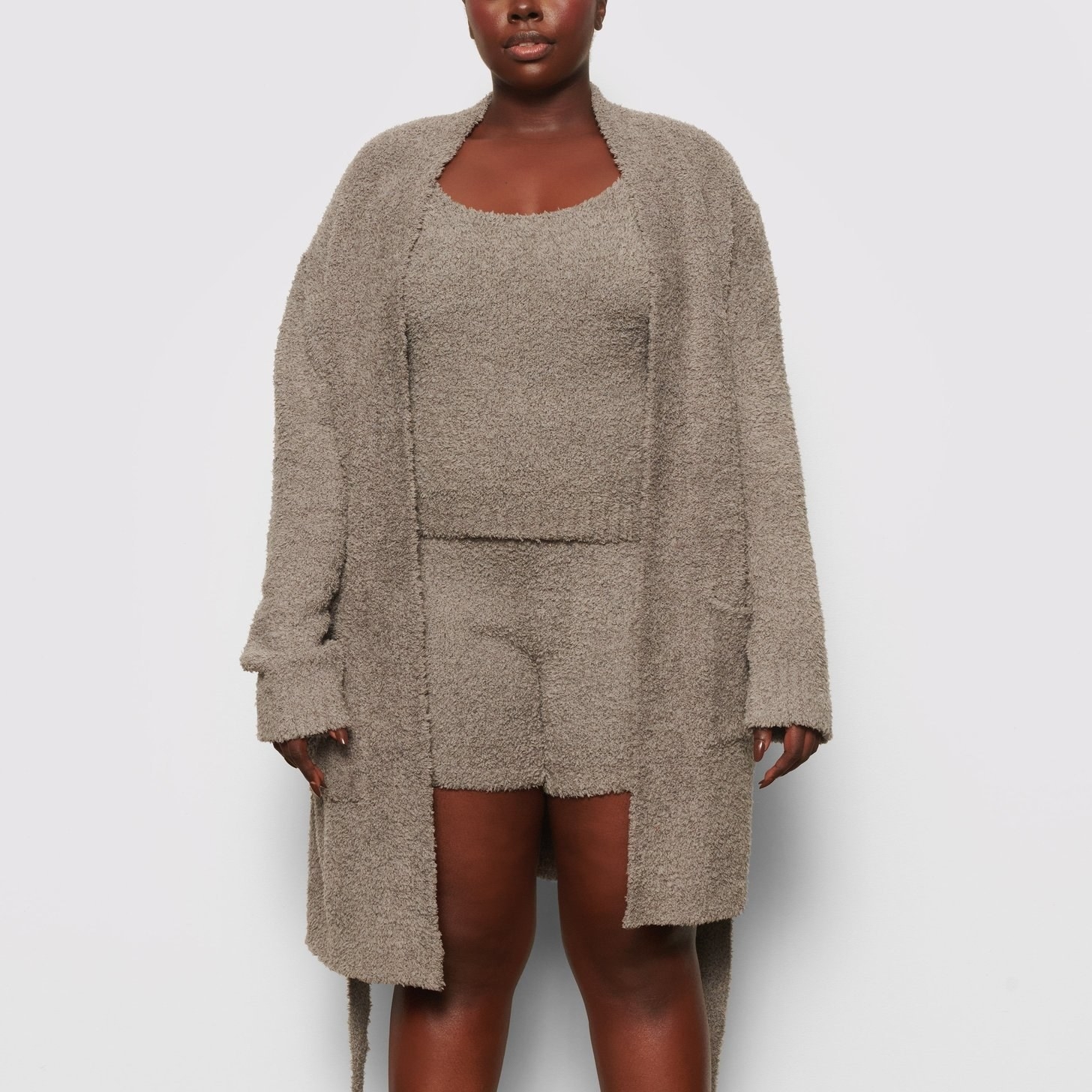 a model in the short robe in gray