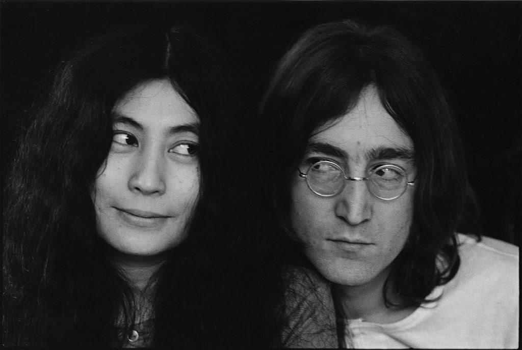 John Lennon and Yoko One looking at each other via side gaze