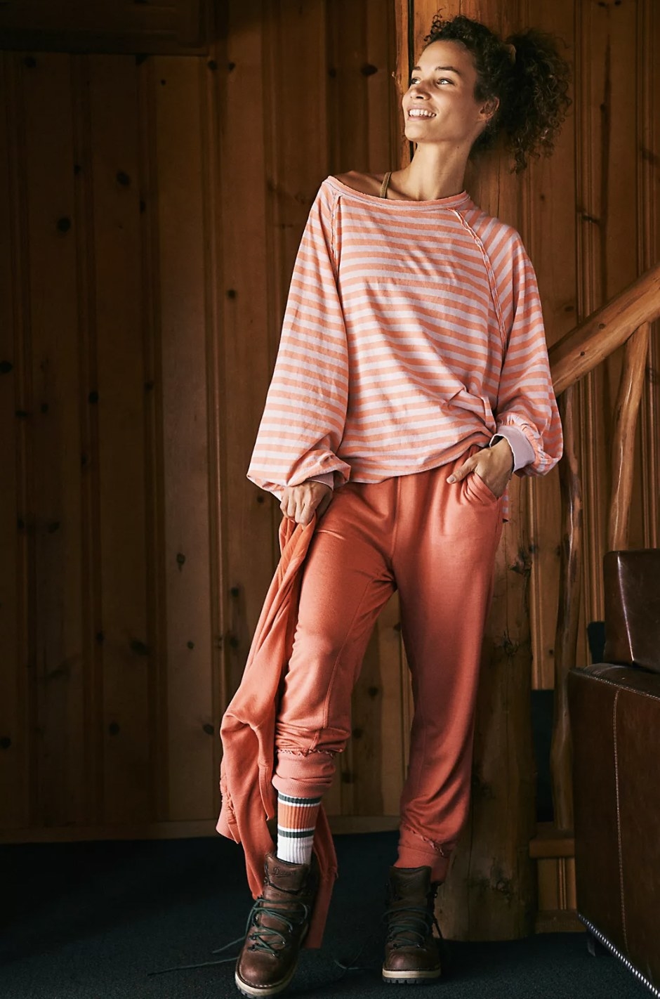 Model wearing the coral striped long-sleeve with matching coral sweats