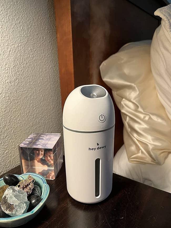 a white Hey Dewy humidifier with water vapor spewing out the top