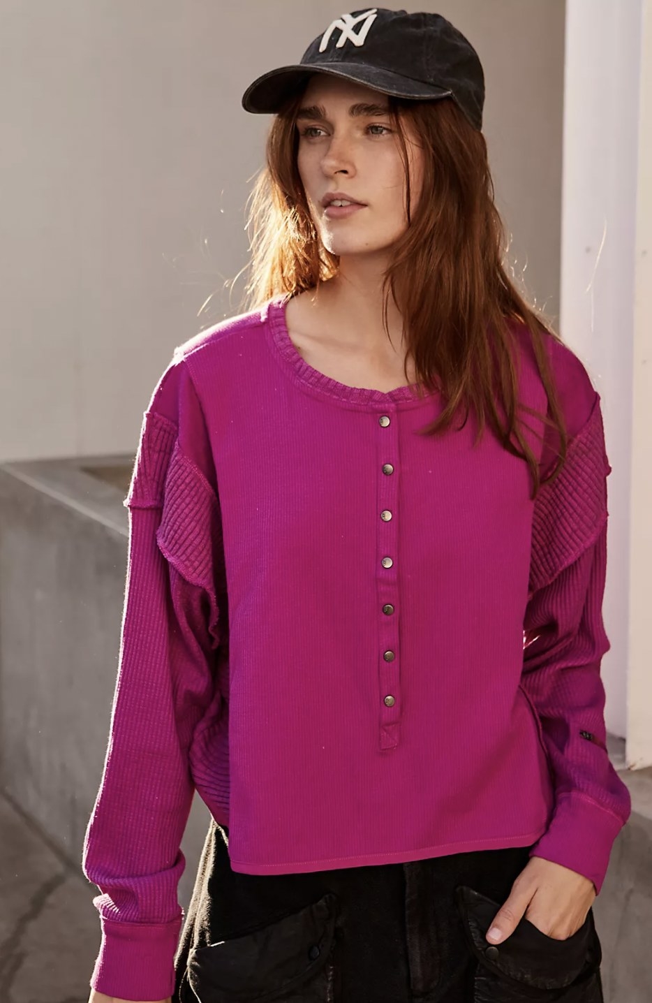 Model wearing the pink button-up henley top