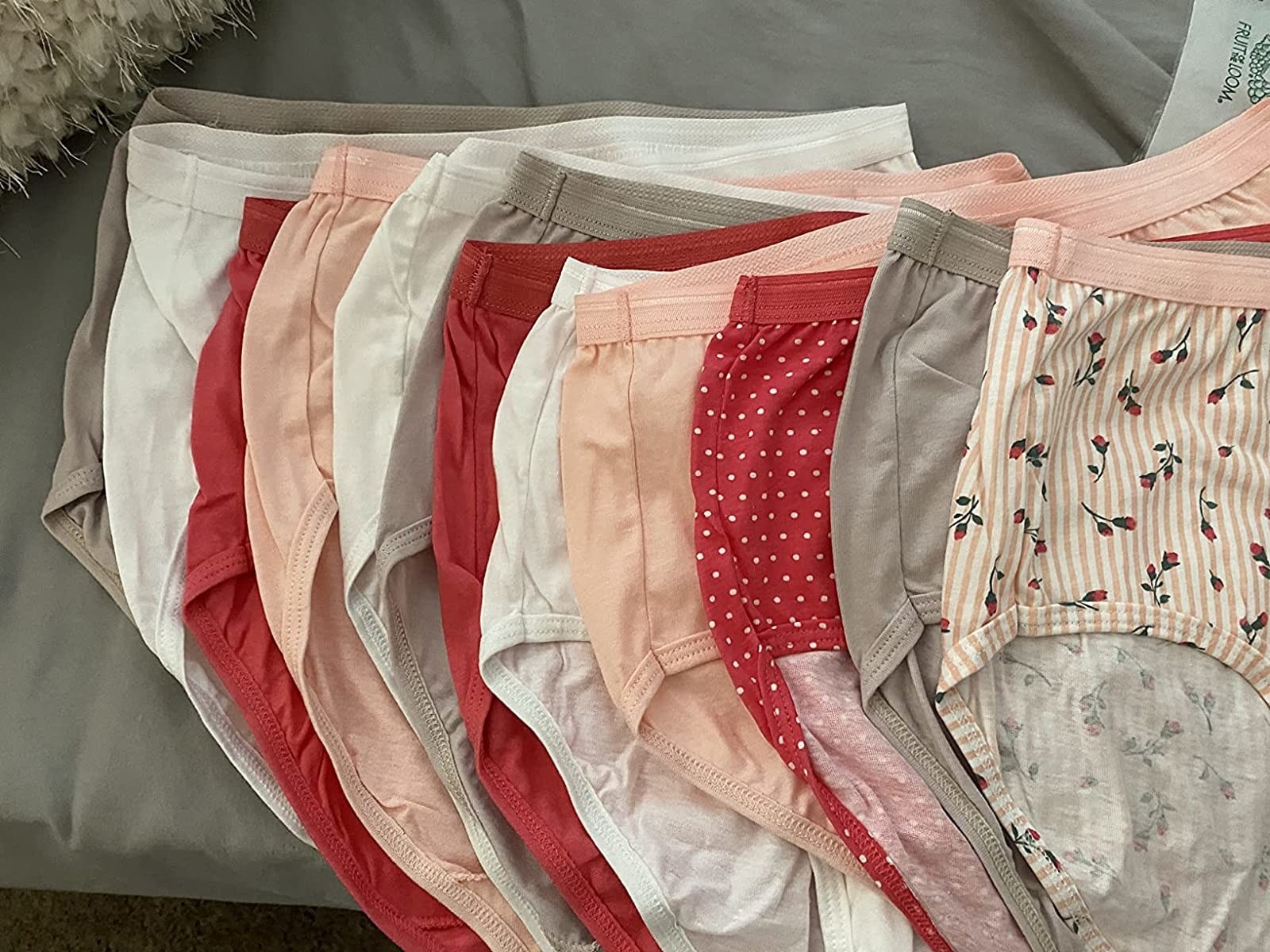 reviewer photo of white, pink, red, and patterned underwear laid out