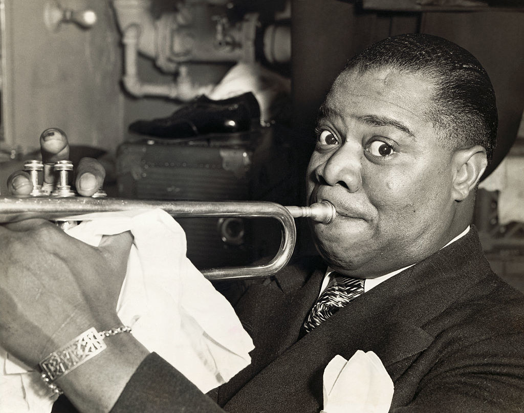 Louis Armstrong plays a trumpet