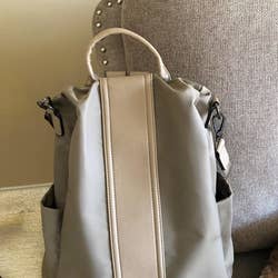 the bag in tan showing the leather strip down the front and top handle