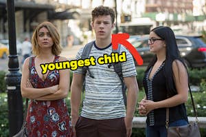 Haley, Luke, and Alex from Modern Family with an arrow pointing to Luke and youngest child typed under his face