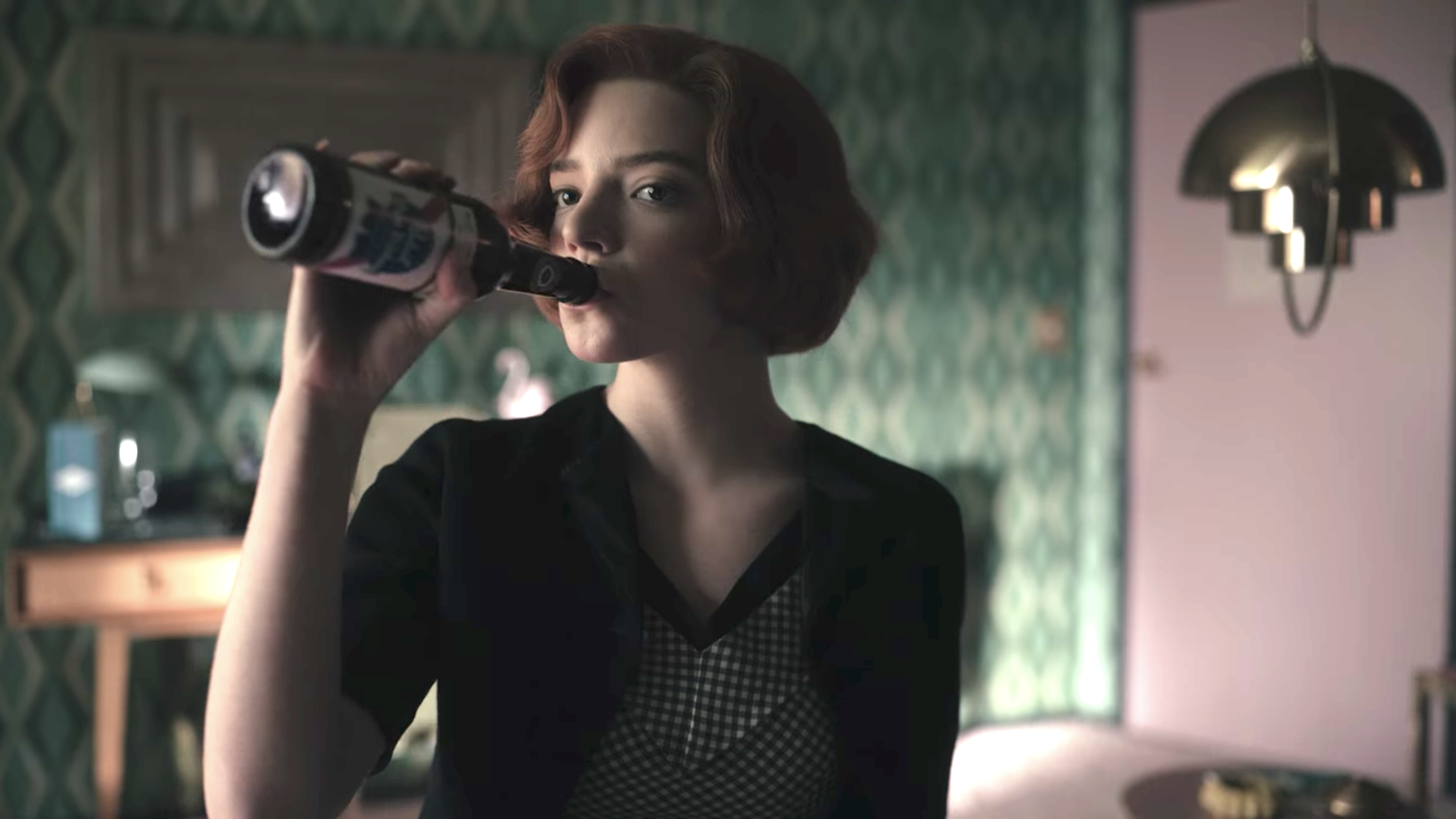 Anya Taylor-Joy as Beth Harmon drinks a bottle of beer in &quot;The Queen&#x27;s Gambit&quot;