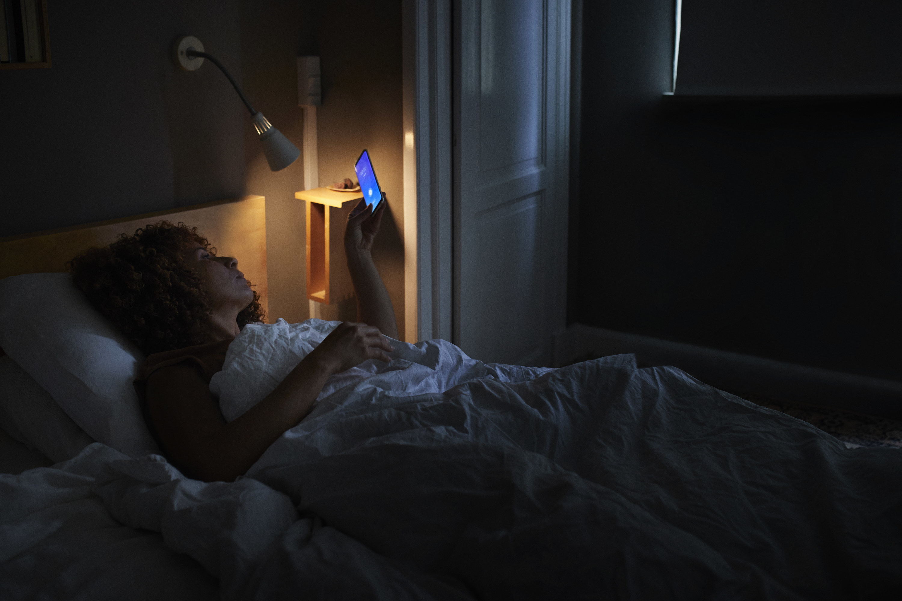 woman turning phone off at night