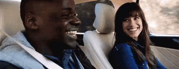 Couple laughs in a car
