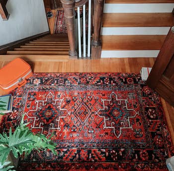 reviewer's large stairway with a rug on the second floor
