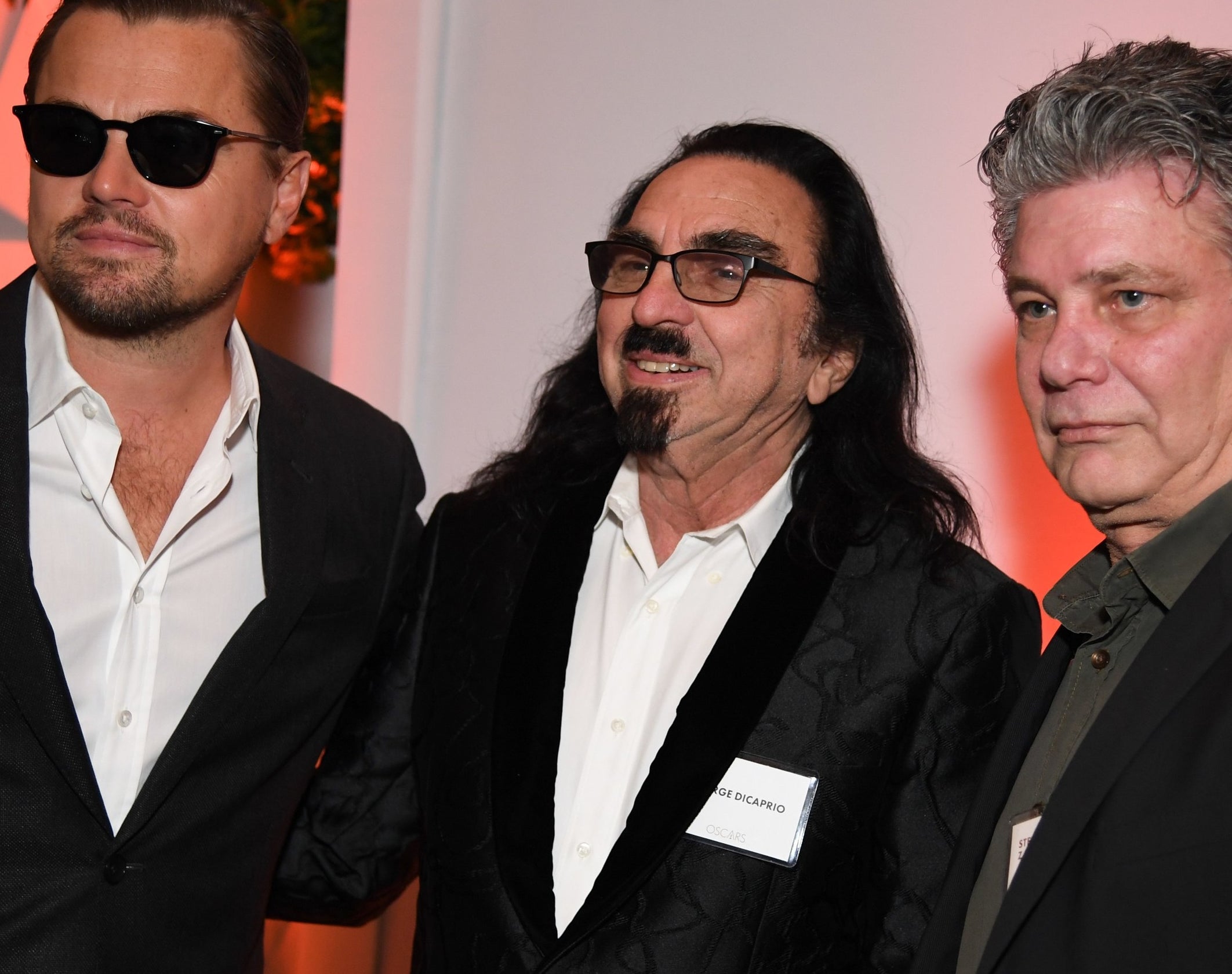 Leo and George stand together at an event