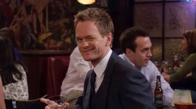 barney winks while wearing a suit and tie