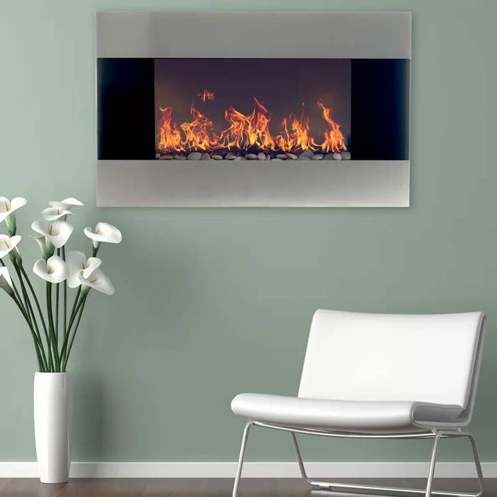 A wall-mounted fireplace in a stainless steel finish