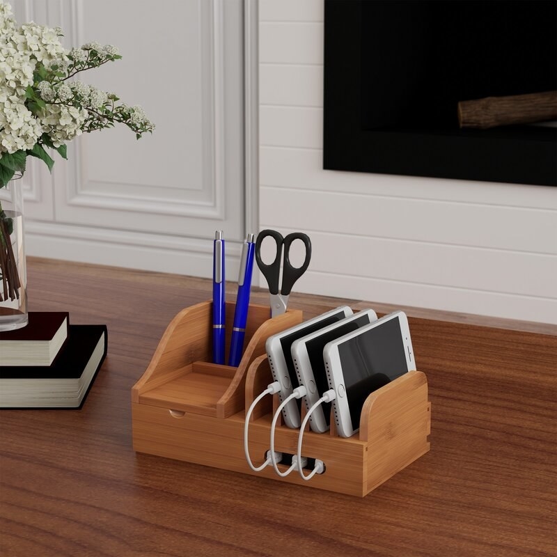 The brown wooden charging station on a desk