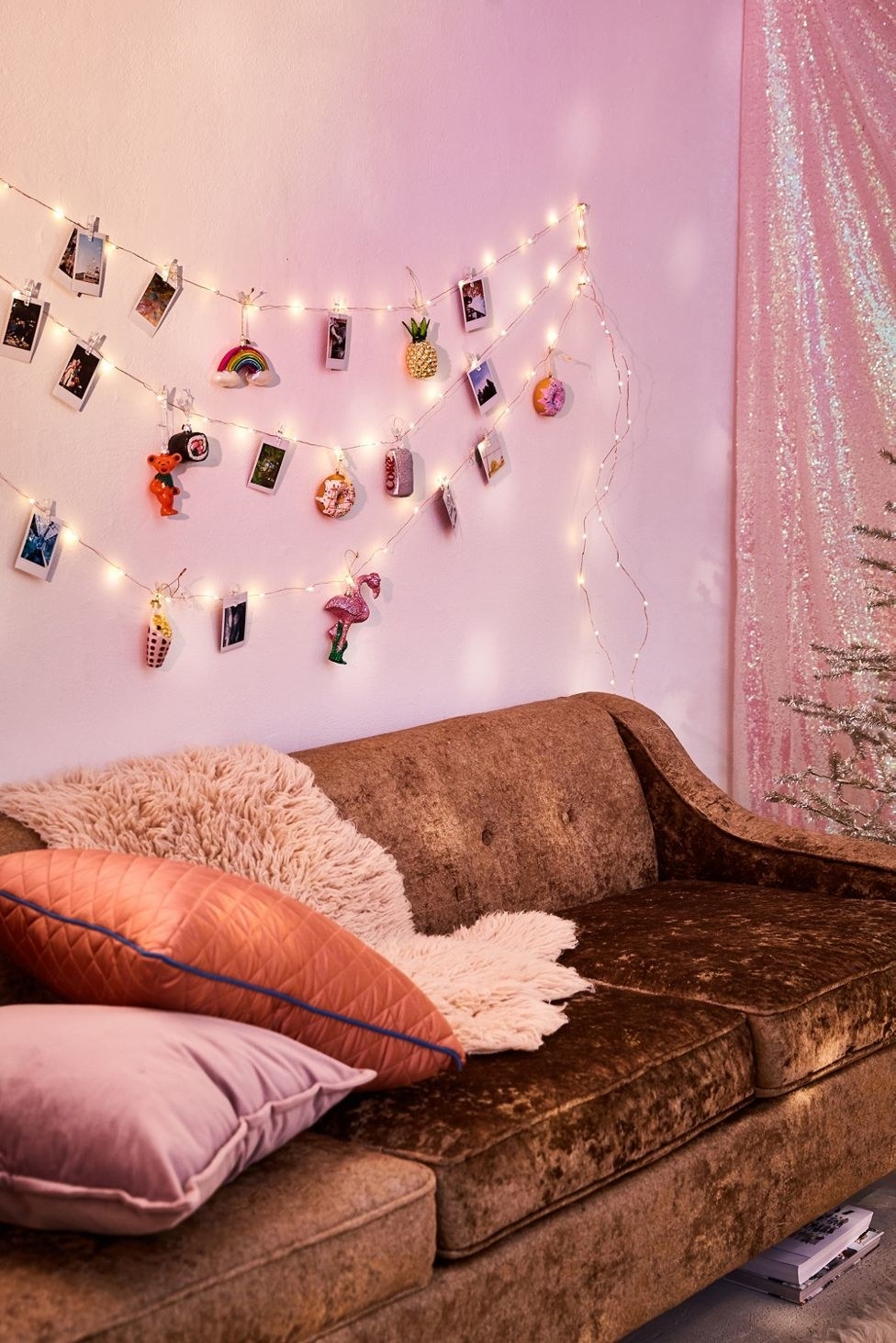 wall with stings of fairy lights and hanging instax photos