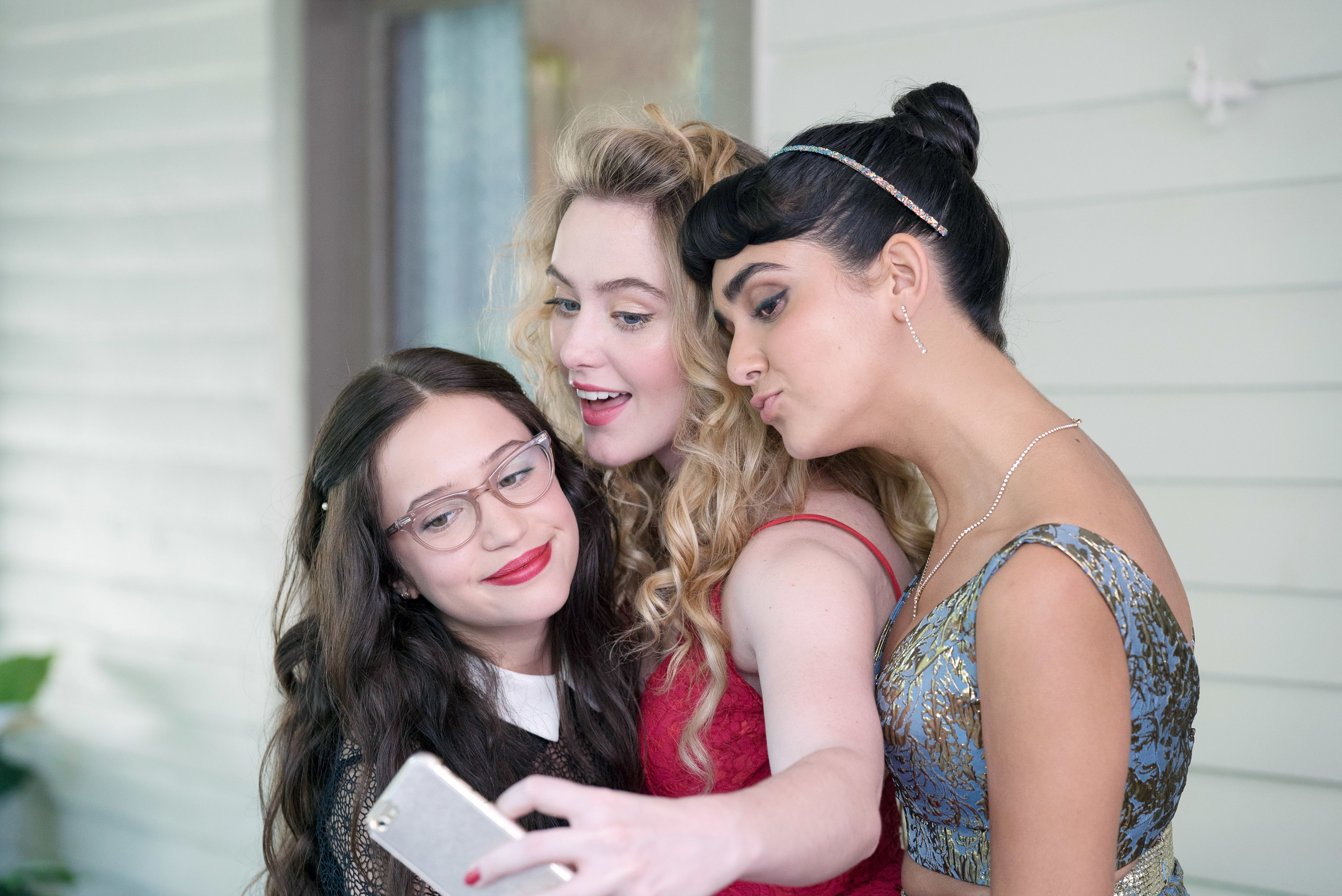 The three main characters take a selfie in their prom looks