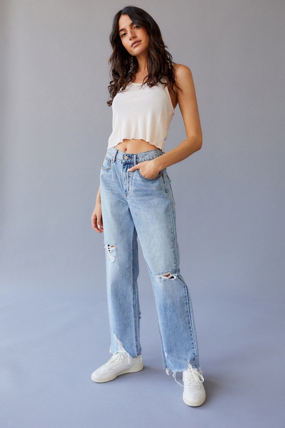 model in light wash distressed straight leg jeans