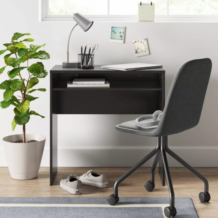 A compact rectangular office desk with an open shelf