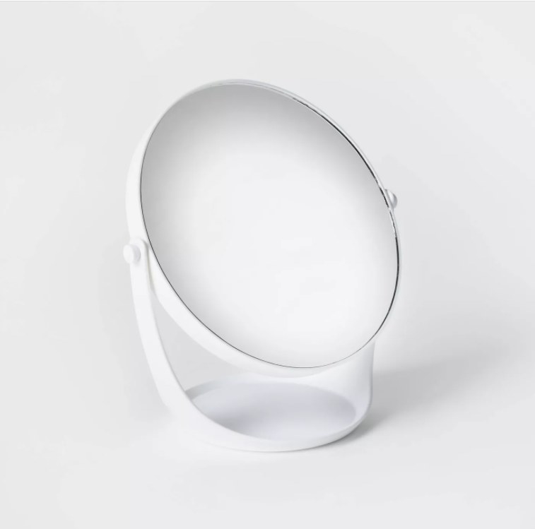 A image of a white plastic vanity mirror