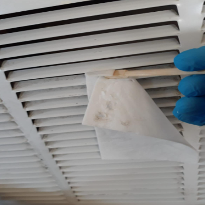 reviewer using sheet to clean air vents