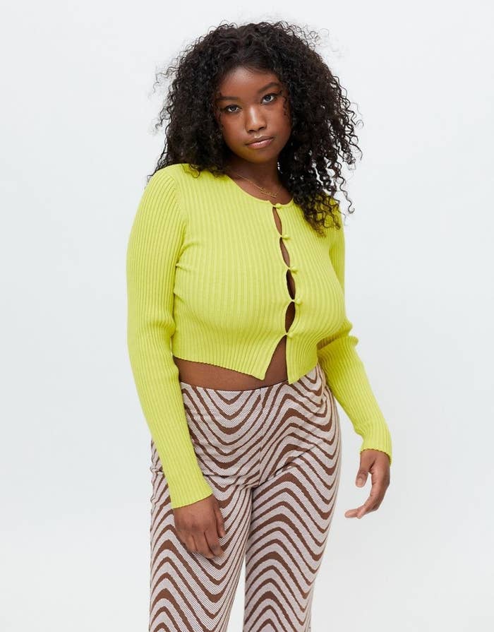 model in a bright green cropped cardigan with buttons