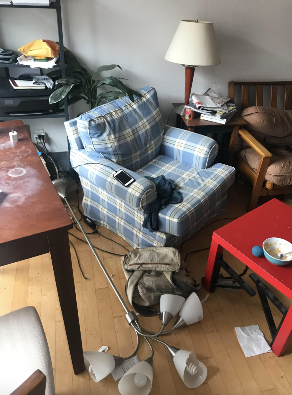 Messy/dirty living room with a broken lamp, dirty kitchen table