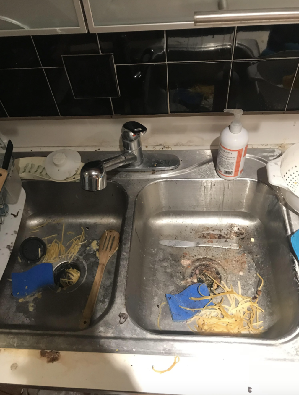 Dirty sink filled with spaghetti