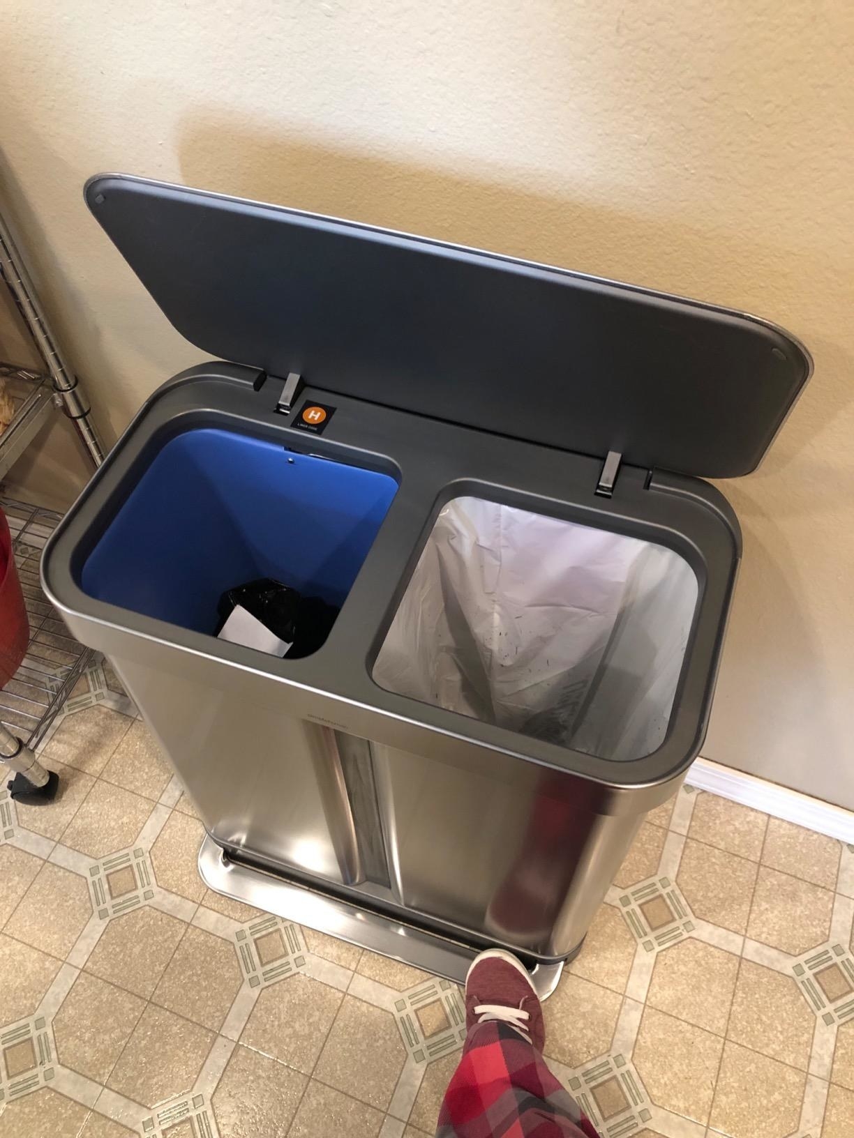 reviewer steps on pedal of dual garbage can