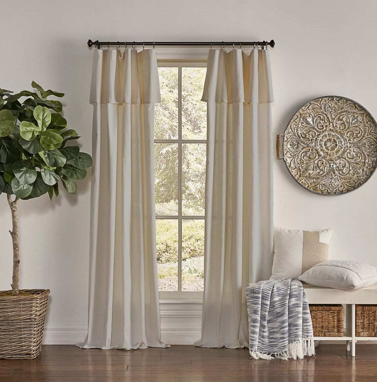 the cream colored curtains on a floor length window