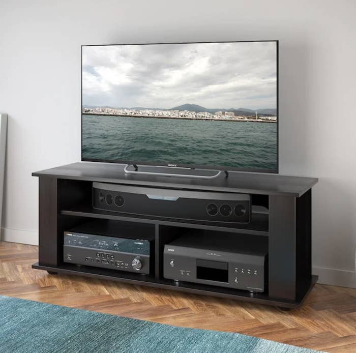 A black TV stand with 3 shelves