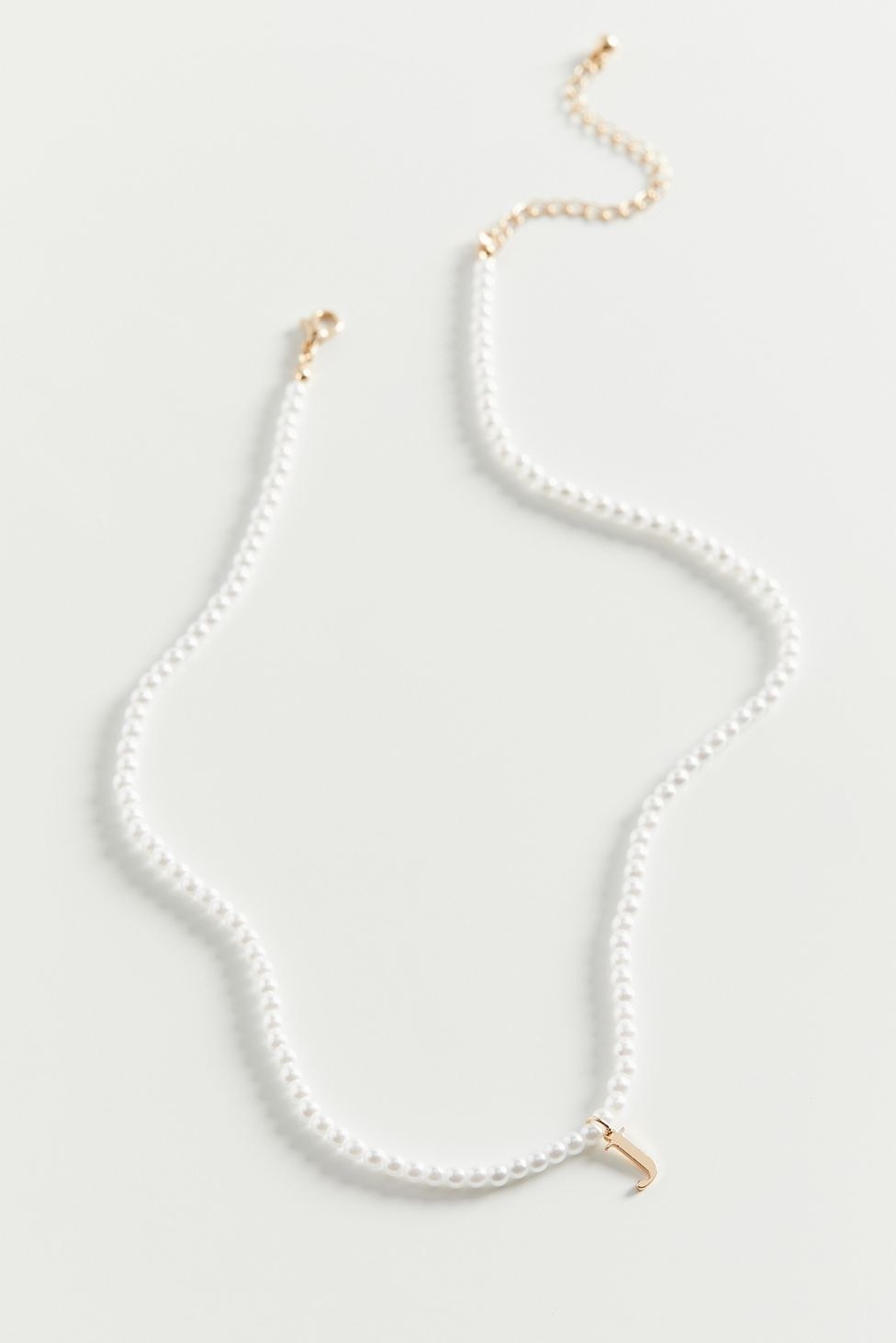 pearl necklace with a gold J charm